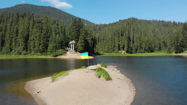 Ukrainian flag proudly flatters on island shore. Travel Ukraine