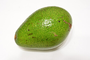 A green avocado fruit isolated on white background, close-up