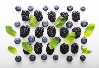 Mix berries with leaf of mint over white background