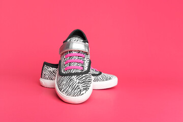 Stylish sneakers on a pink background. There is space for text.