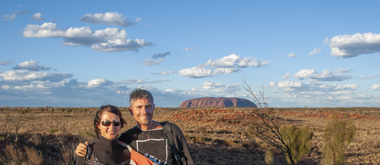 Portrait of a happy caucasian couple hiking along the australian outback on a beautiful sunny day
