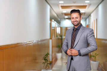 Young indian businessman Giving expression at office.