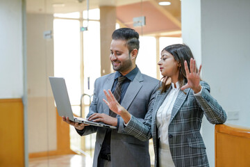 Young Indian businessman Guiding his female secretary at office