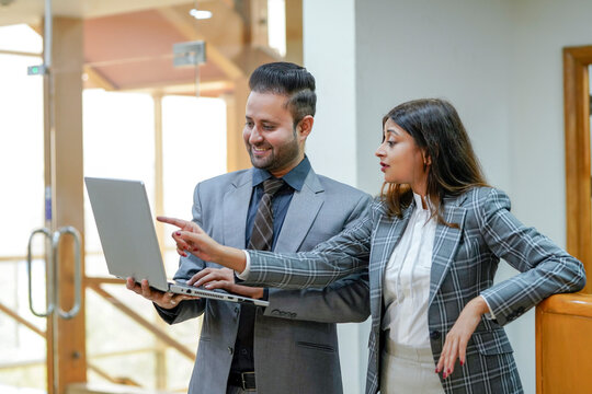 Young Indian businessman Guiding his female secretary at office
