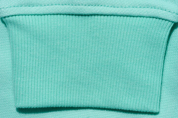 Mint cotton sweater sleeve, close up