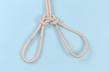 Rope knot Spanish bowline on a blue background