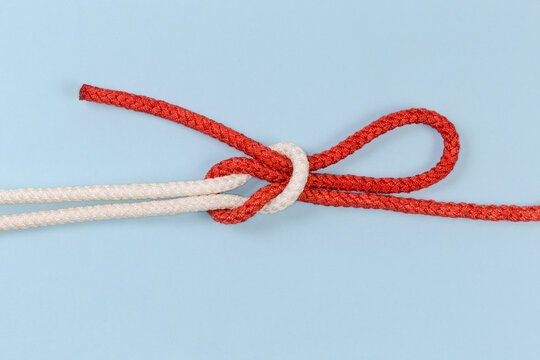 Rope Singly slipped reef knot on a blue background