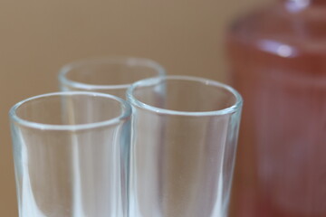 Shot glasses with pink alcohol bottle