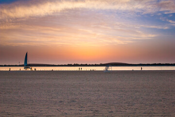 Fototapeta premium sunset on the beach with orange and blue sky