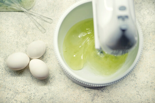 The Process Of Whipping Egg Whites With A Hand Mixer. Process Of Making Biscuit. Homemade Cakes