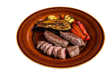 Grilled mutton tenderloin Fillet Meat, lamb sirloin on rustic plate with vegetables.  Isolated, transparent background