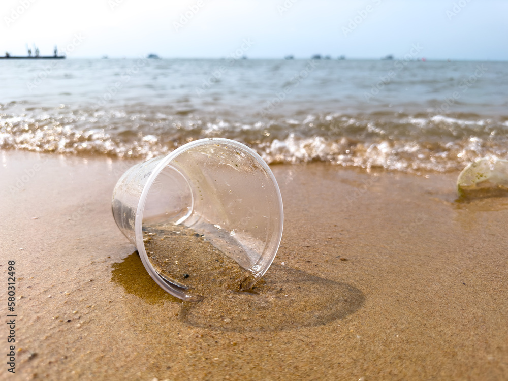 Wall mural plastic cup waste on beach