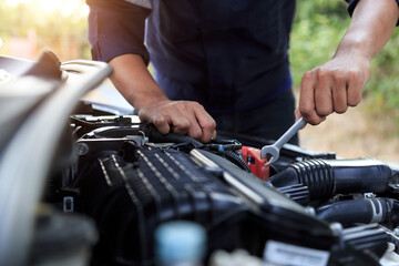 Automobile mechanic repairman hands repairing a car engine automotive workshop with a wrench, car service and maintenance,Repair service.
