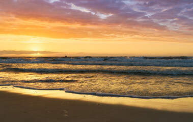 Fototapeta na wymiar Sunset on Baltic Sea white bright golden orange color and rough sea 
