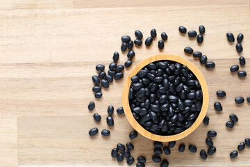Top view of black beans in a bowl on wooder background, Healthy eating concept