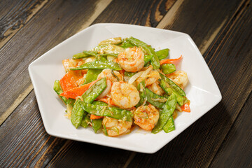Sautéed Shrimp with Snow Peas on Simple Background