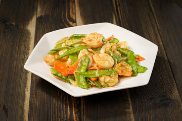 Sautéed Shrimp with Snow Peas on Simple Background