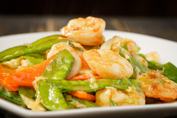 Sautéed Shrimp with Snow Peas on Simple Background