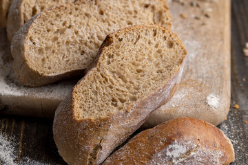 Cut into pieces fresh baked loaf of dark bread