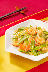 Sautéed Shrimp with Snow Peas on Simple Background