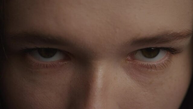 Angry woman eyes looking at camera close up