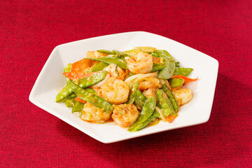 Sautéed Shrimp with Snow Peas on Simple Background