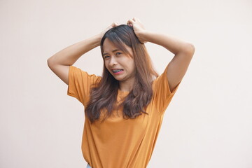 Fototapeta premium Asian woman having itchy head from dandruff