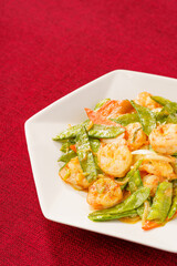 Sautéed Shrimp with Snow Peas on Simple Background