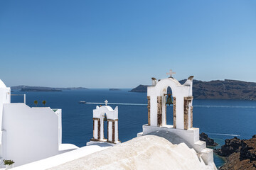 White bell towers in Oia. Santorini, Greece.