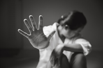 Image black and white of stop violence against women concept, international women's day. Female hand raised in fear and stop sexual harassment. Women are depressed by bullying and abuse. family threat