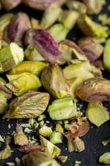 Scattered pistachios of green color with salty taste