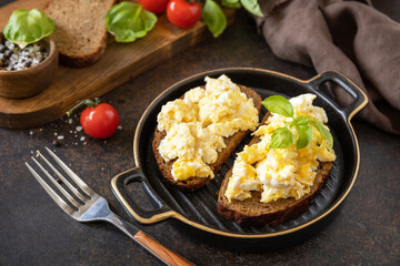 Scrambled eggs on whole grain bread. Homemade breakfast or brunch meal - scrambled eggs.