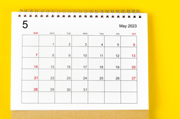 The May 2023 Monthly desk calendar for 2023 year on yellow background.