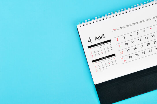 Close up April 2023 Monthly desk calendar for 2023 year on blue background.