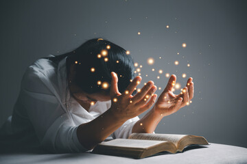 woman kneeling and praying in modern house at sunset time. Female catholic prayer worship to God...