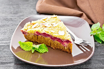 Pie with raspberries in brown plate on board