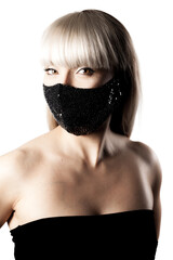 Beautiful brunette girl with blond hair fringe bangs wearing black fashionable protective face mask..