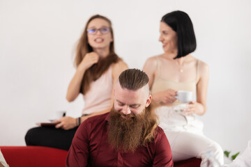 Successful startup team during coffee break. Colleagues talking and acting casual in an office.