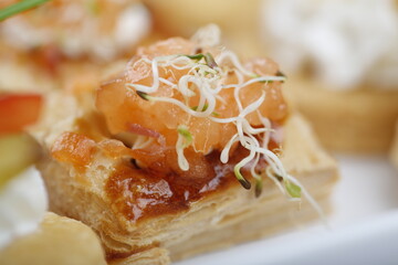 Delicious salmon and pastry finger food snack close up