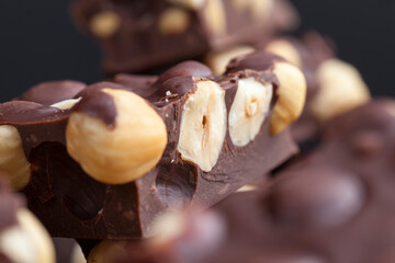 Pieces of homemade milk chocolate with lots of hazelnuts
