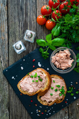 Tasty sandwiches with liverwurst and chive on wooden table
