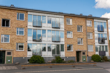 Typical low-rise residential building in Sweden. Modern stylish European architecture. House from bricks. Little balconies.