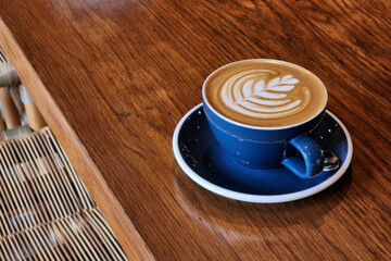 Nice Texture of Latte art on hot latte coffee . Milk foam in heart shape leaf tree on top of latte art from professional barista artist - 580326883