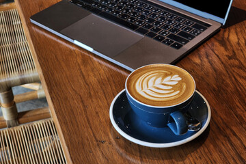 Nice Texture of Latte art on hot latte coffee . Milk foam in heart shape leaf tree on top of latte...