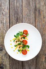 Prawn salad on wooden table
