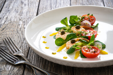Prawn salad on wooden table
