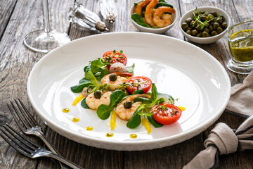 Prawn salad on wooden table
