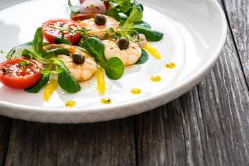 Prawn salad on wooden table
