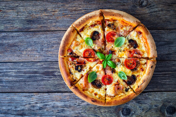 Circle pizza with boiled ham and  mushrooms on wooden table

