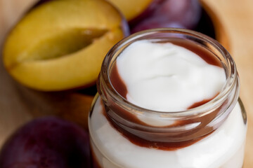 Ripe dark - colored plums sliced on the table